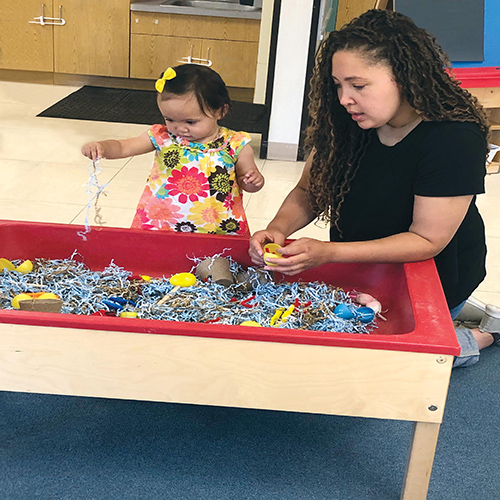  Adult playing with toddler